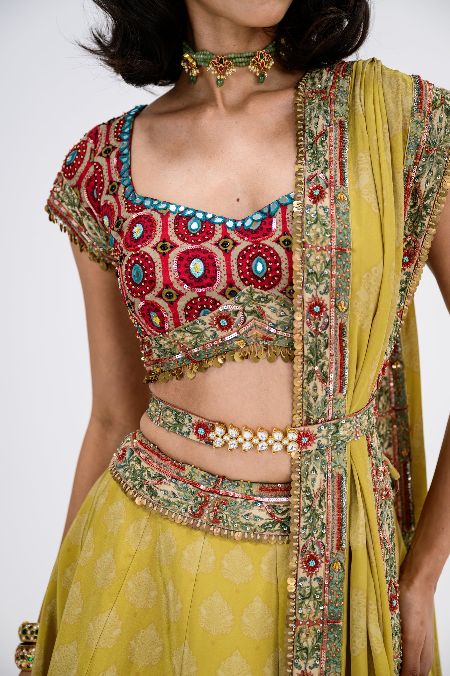 Mustard Print Lehenga Paired With Red Honey Comb Bralette And Dupatta