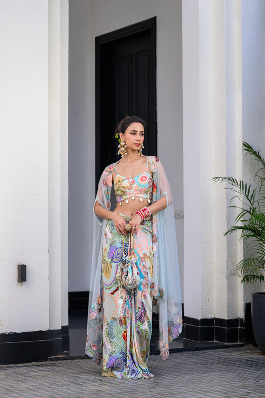 GARDENIA DHOTI SKIRT SET PAIRED WITH HIGHLITED BRALLETEE WITH  HIGHLIGHTED APLLIQUE CAPE