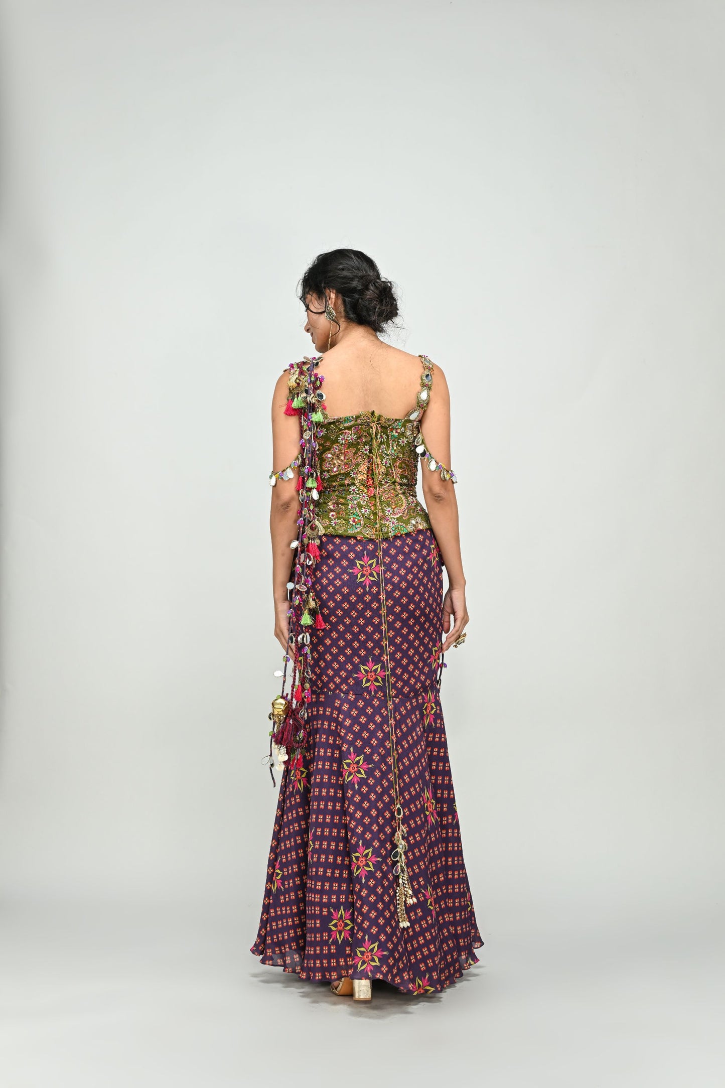 PLUM PRESTITCHED TASSEL SAREE PAIRED WITH BADLA EMBROIDERED GREEN CORSET
