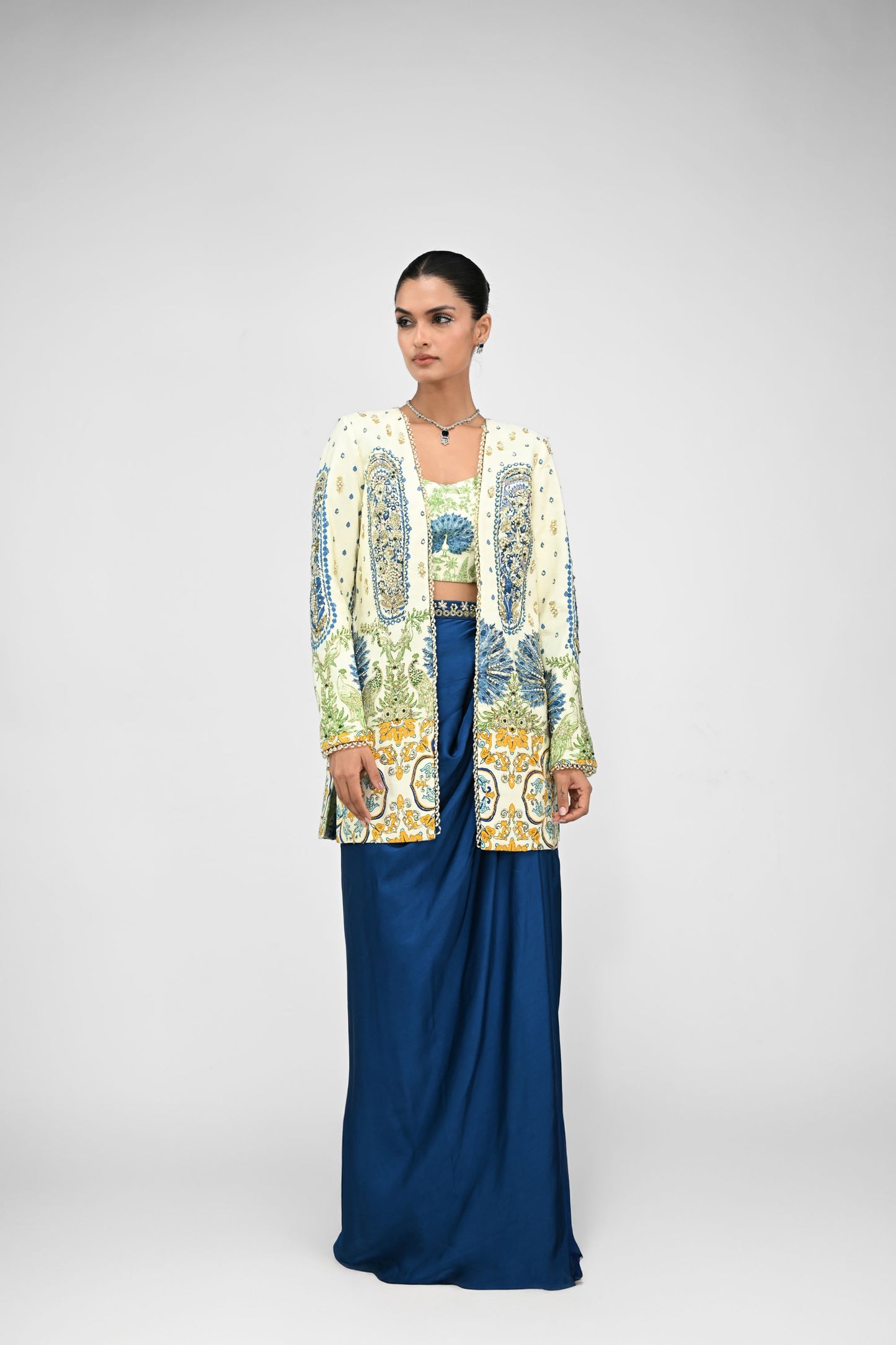 Royal Highlighted Blazer Paired With Peacock Bralette And Blue Cowl Skirt