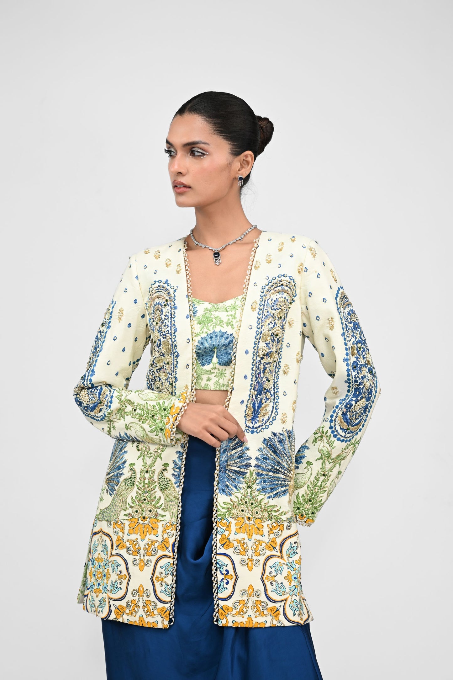 Royal Highlighted Blazer Paired With Peacock Bralette And Blue Cowl Skirt