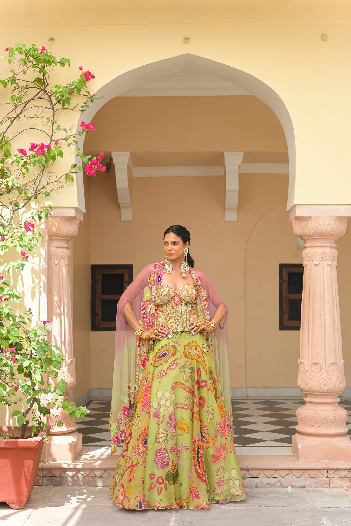 OLIVE BLOOM PRINTED LEHENGA AND EMBROIDERED. MIRROR CORSET AND APPLIQUÉ DUAL CAPE HIGHLIGHT