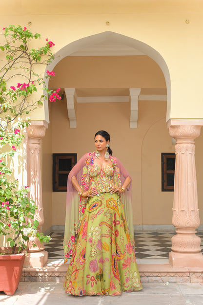 OLIVE BLOOM PRINTED LEHENGA AND EMBROIDERED. MIRROR CORSET AND APPLIQUÉ DUAL CAPE HIGHLIGHT