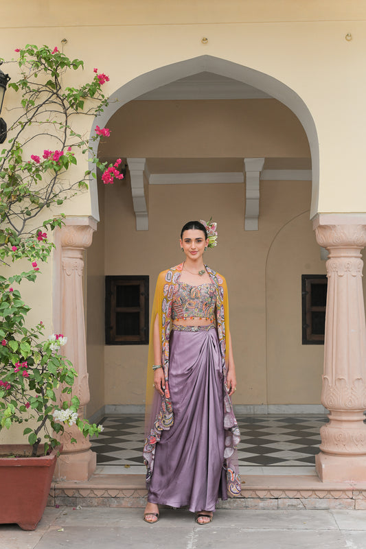 PURPLE COWL SATIN SKIRT WITH VIOLET BLOOM HIGHLIGHT CORSET BLOUSE AND DUAL APPLIQUÉ HIGHLIGHT CAPE SET