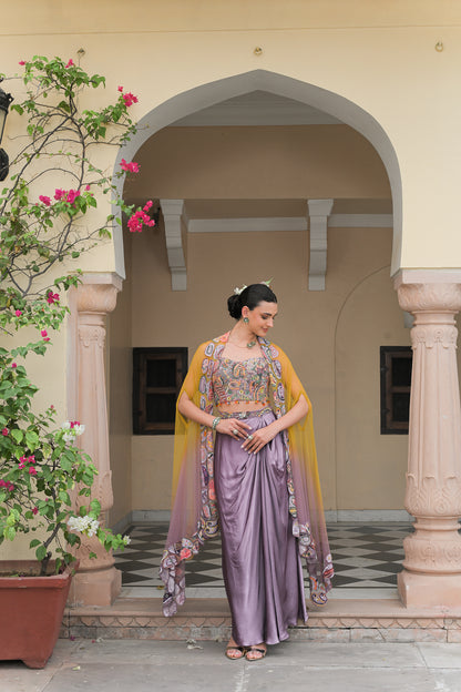 PURPLE COWL SATIN SKIRT WITH VIOLET BLOOM HIGHLIGHT CORSET BLOUSE AND DUAL APPLIQUÉ HIGHLIGHT CAPE SET