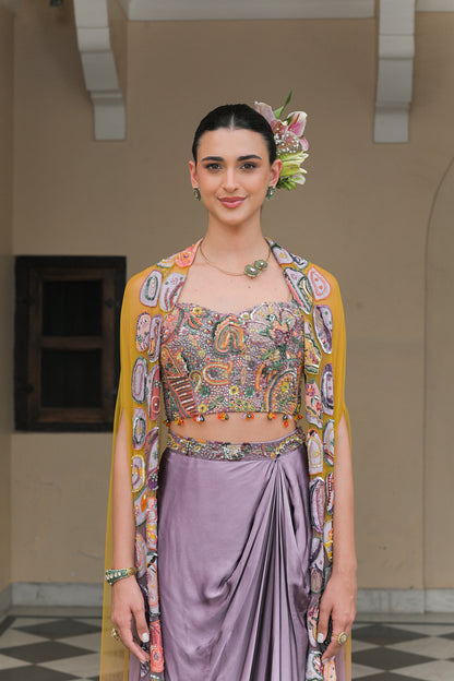PURPLE COWL SATIN SKIRT WITH VIOLET BLOOM HIGHLIGHT CORSET BLOUSE AND DUAL APPLIQUÉ HIGHLIGHT CAPE SET