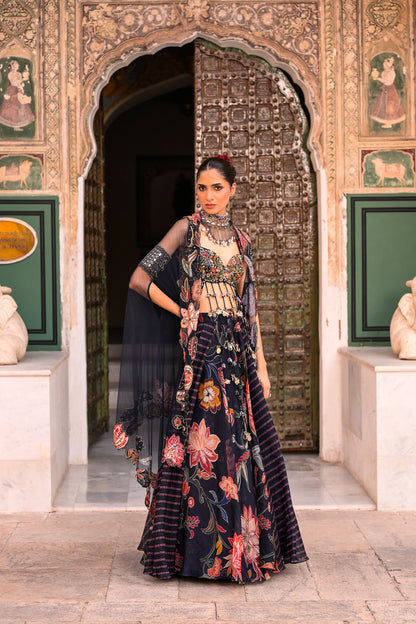 DUEL PRINTED LEHANGA WITH EMB TASSLE BLOUSE WITH APLIQUE CAPE