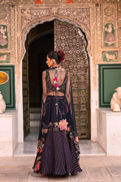 DUEL PRINTED LEHANGA WITH EMB TASSLE BLOUSE WITH APLIQUE CAPE
