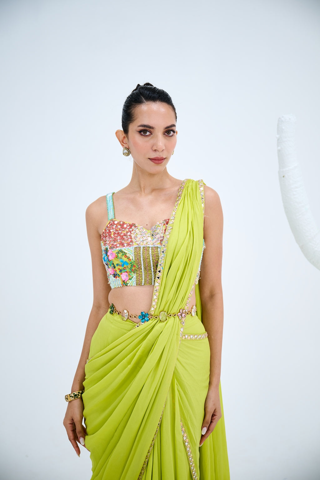 LIGHT GREEN PRE DRAPED SAREE PAIRED WITH EMBROIDERED CORSET AND EMEBELISHED BELT