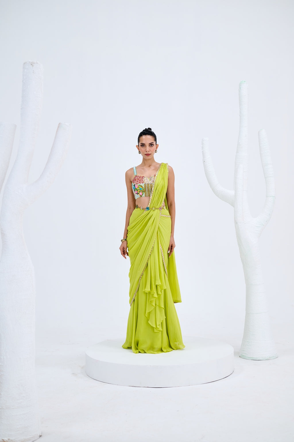 LIGHT GREEN PRE DRAPED SAREE PAIRED WITH EMBROIDERED CORSET AND EMEBELISHED BELT