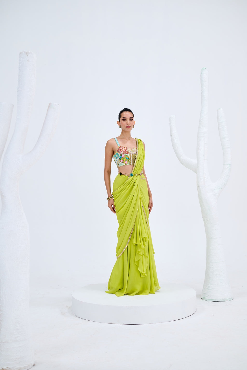 LIGHT GREEN PRE DRAPED SAREE PAIRED WITH EMBROIDERED CORSET AND EMEBELISHED BELT