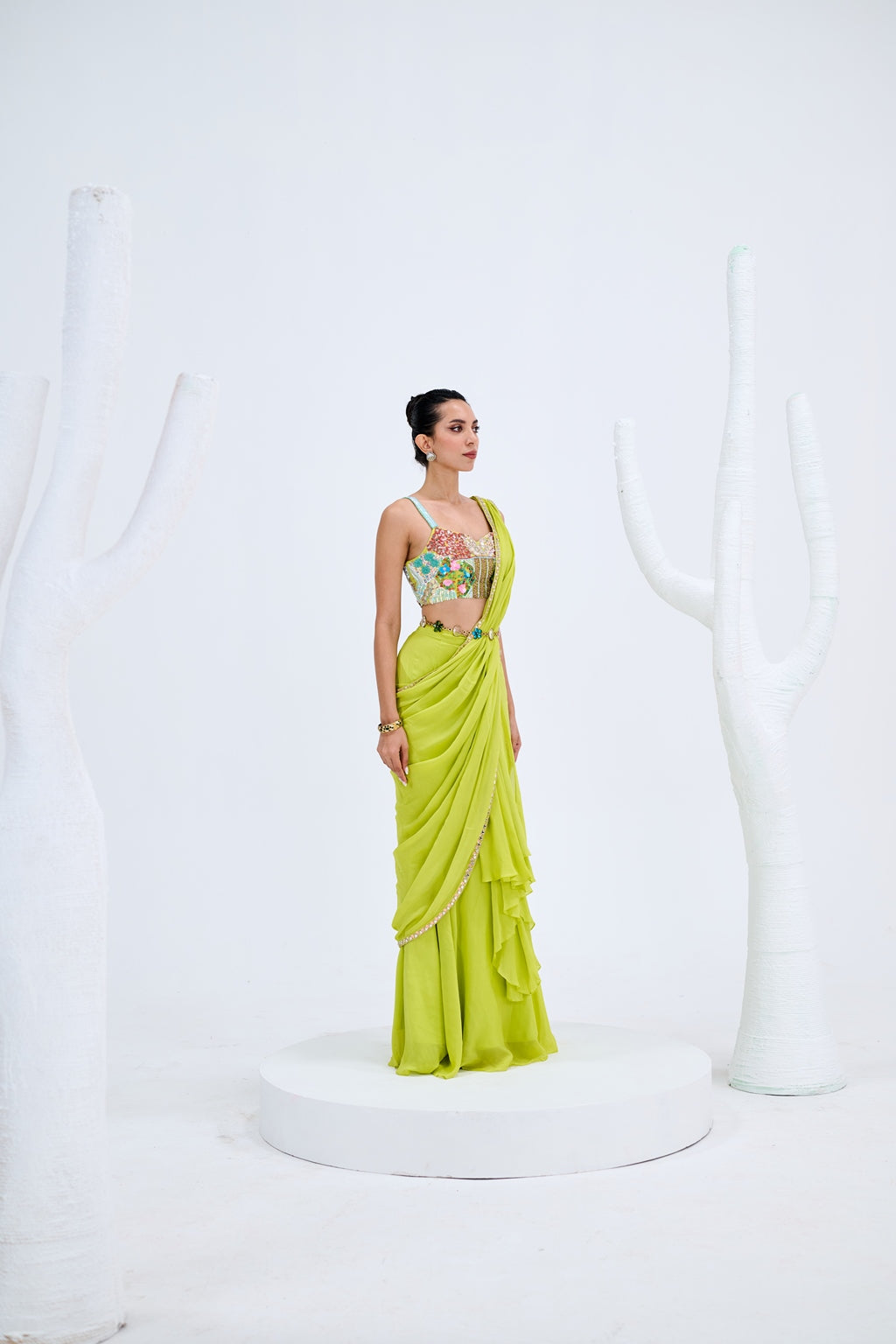 LIGHT GREEN PRE DRAPED SAREE PAIRED WITH EMBROIDERED CORSET AND EMEBELISHED BELT